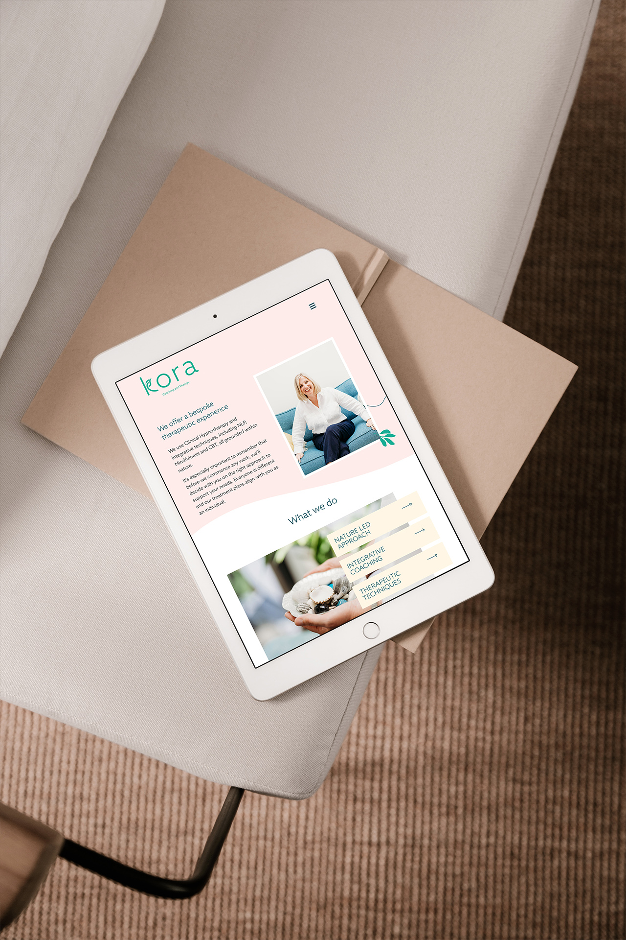 Kora Website design - subpage on iPad sitting on sofa